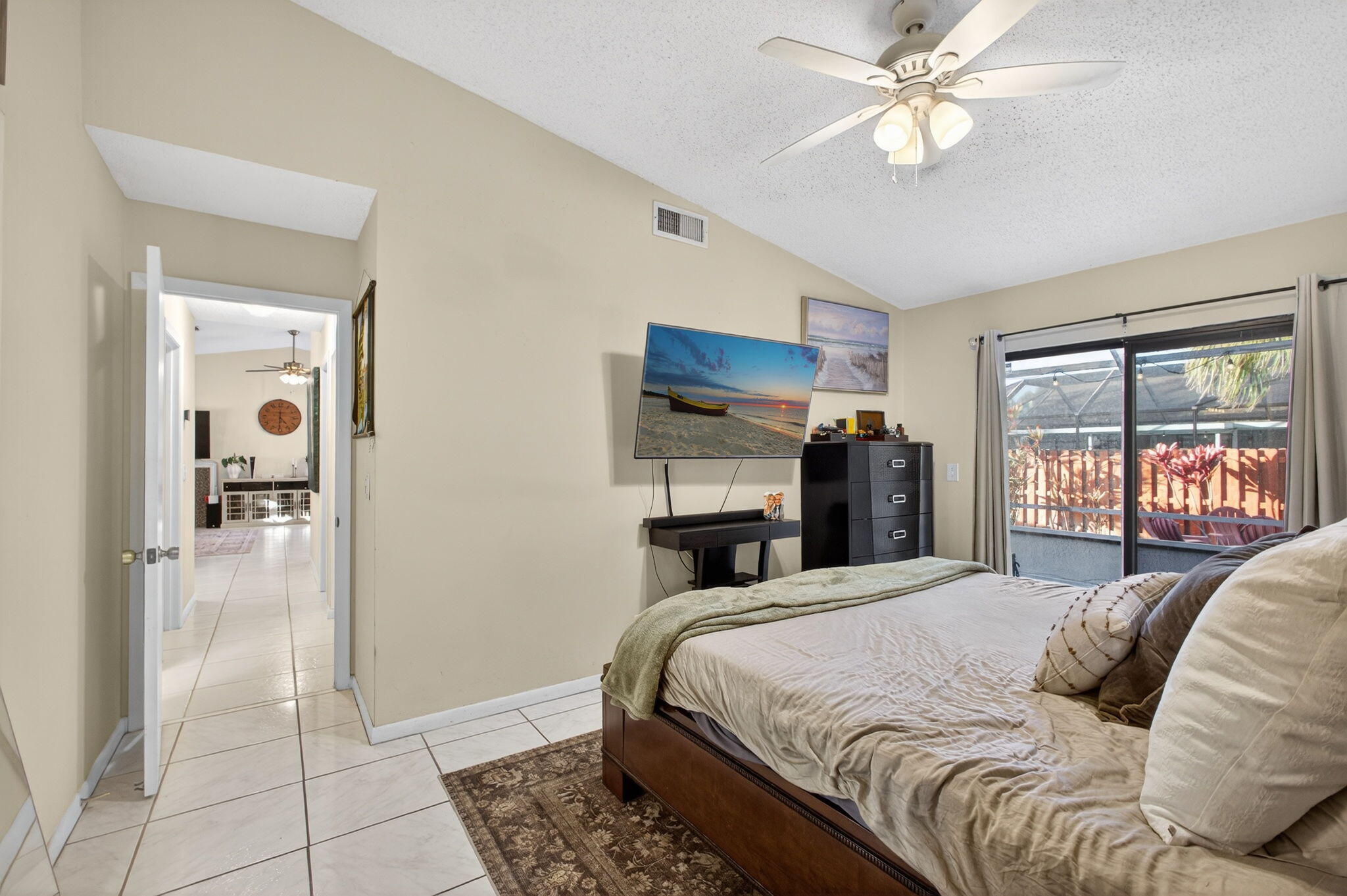 154 Rosewood Circle Jupiter, FL 33458 - Photo 21 of 43 a bedroom with a large bed and a chandelier