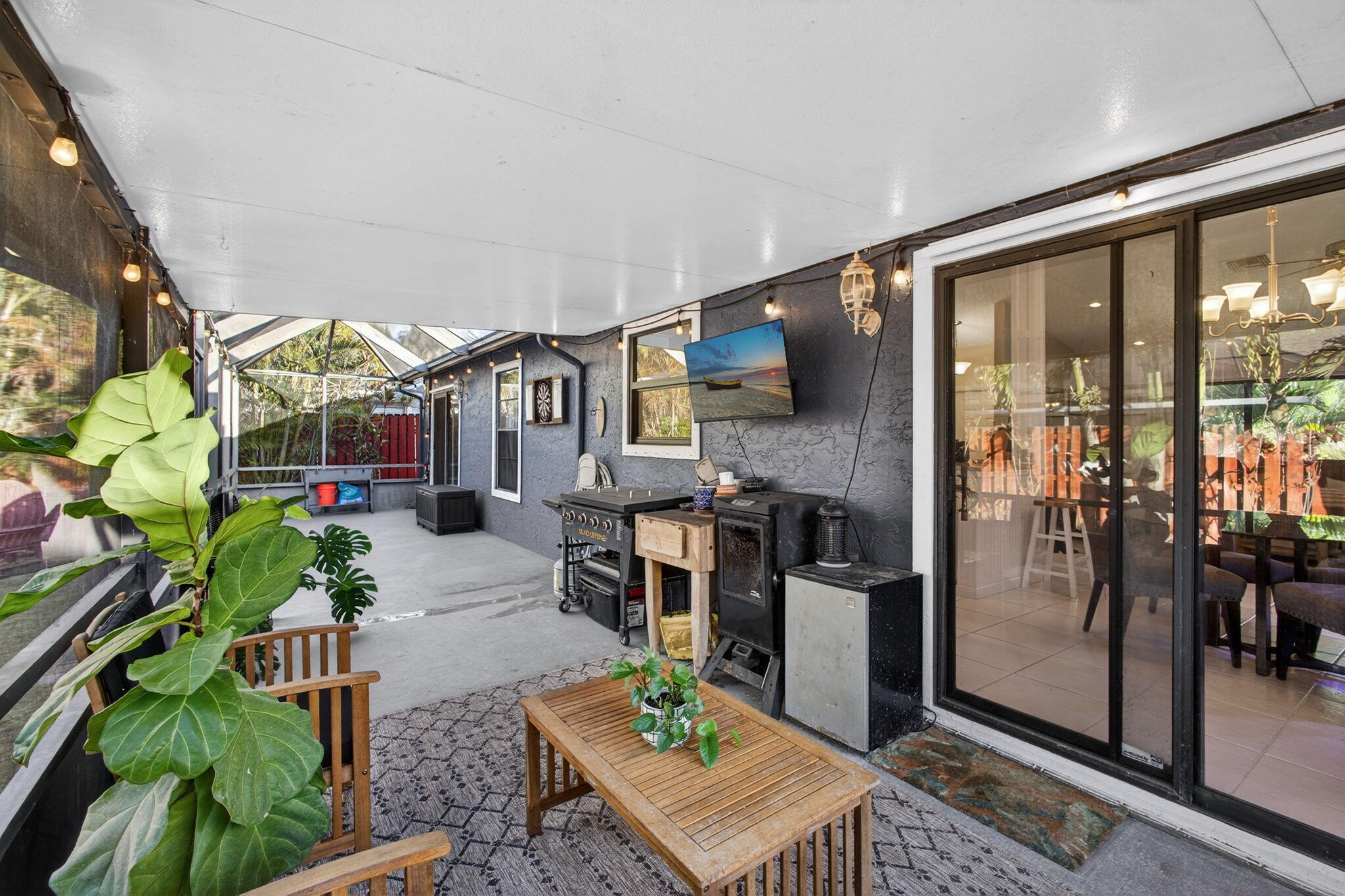 154 Rosewood Circle Jupiter, FL 33458 - Photo 32 of 43 a living room with patio furniture and a floor to ceiling window