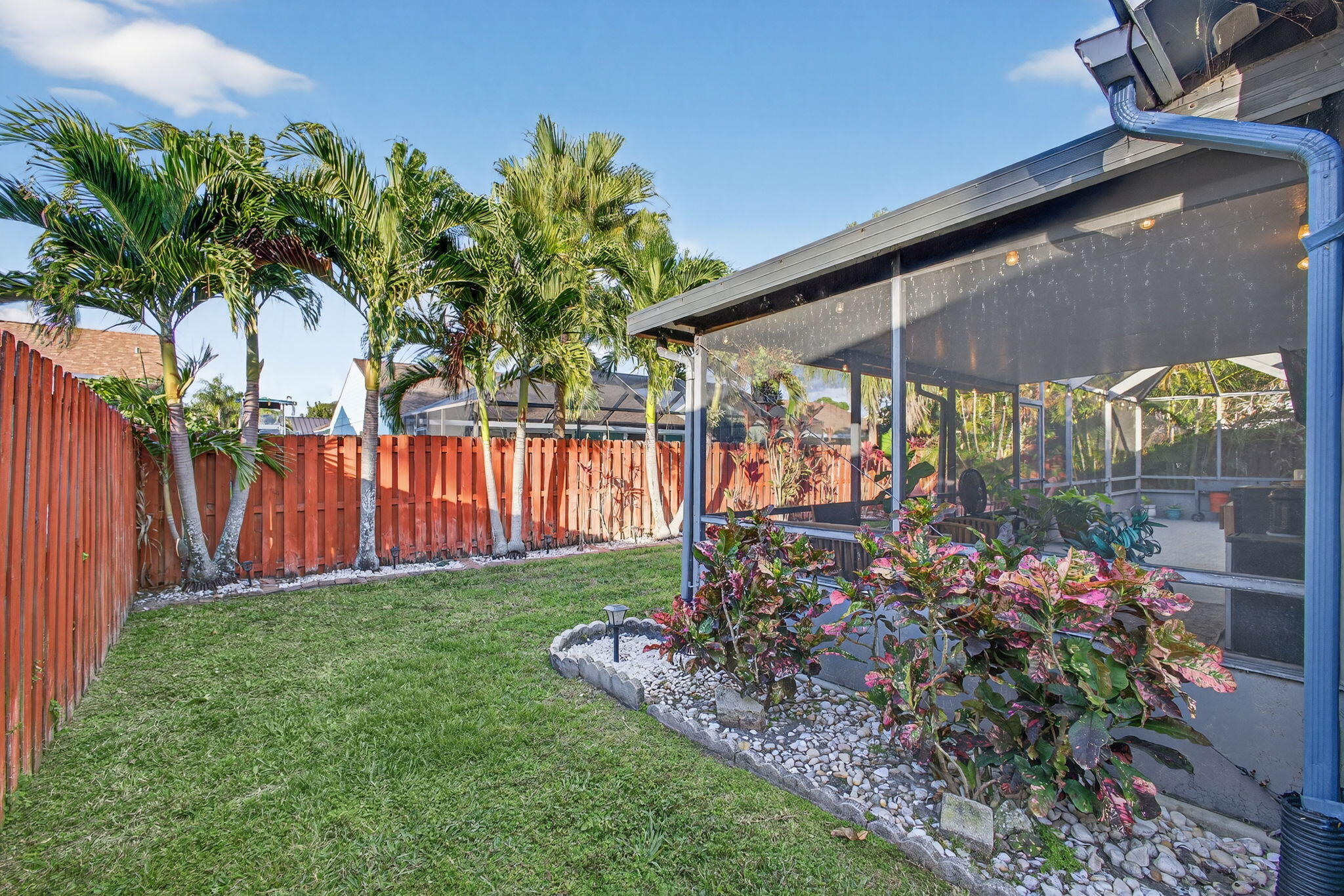 154 Rosewood Circle Jupiter, FL 33458 - Photo 36 of 43 a view of a backyard with a garden