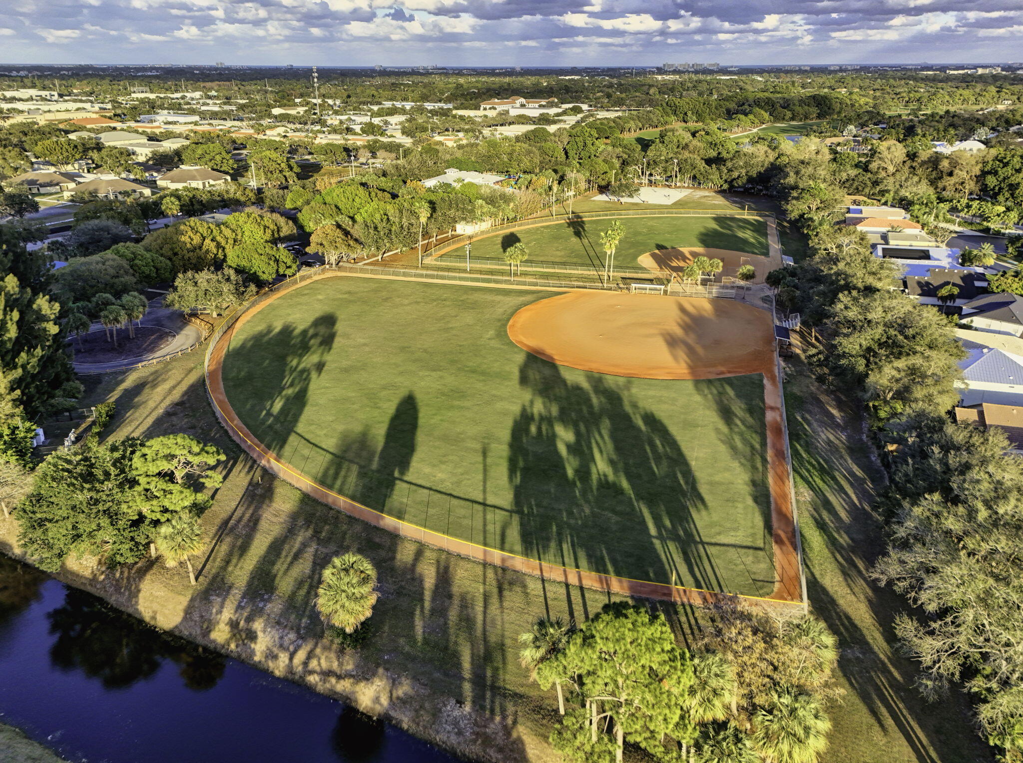154 Rosewood Circle Jupiter, FL 33458 - Photo 41 of 43 a view of a swimming pool with a yard