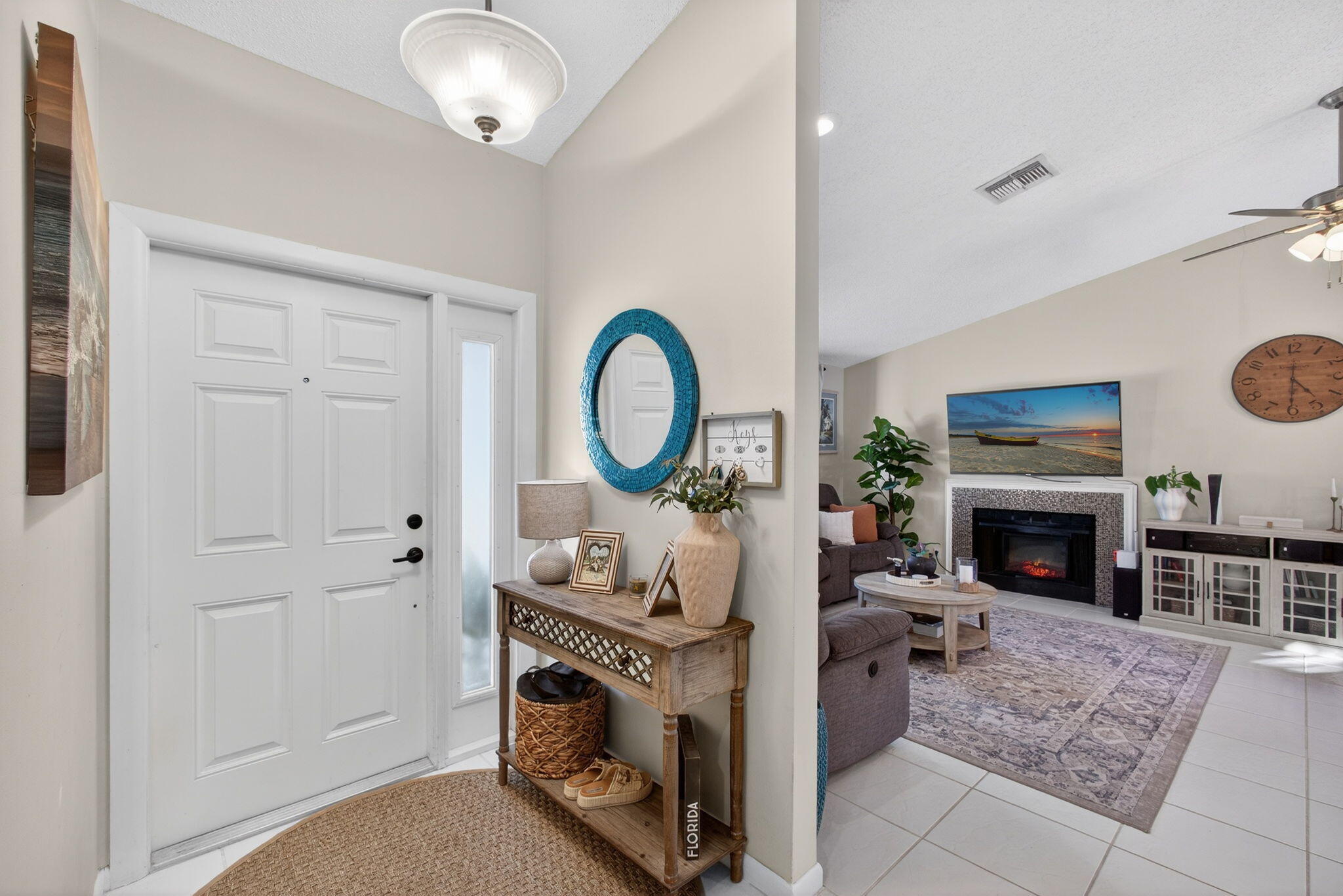 154 Rosewood Circle Jupiter, FL 33458 - Photo 5 of 43 a living room with furniture a fireplace and a dining table with wooden floor