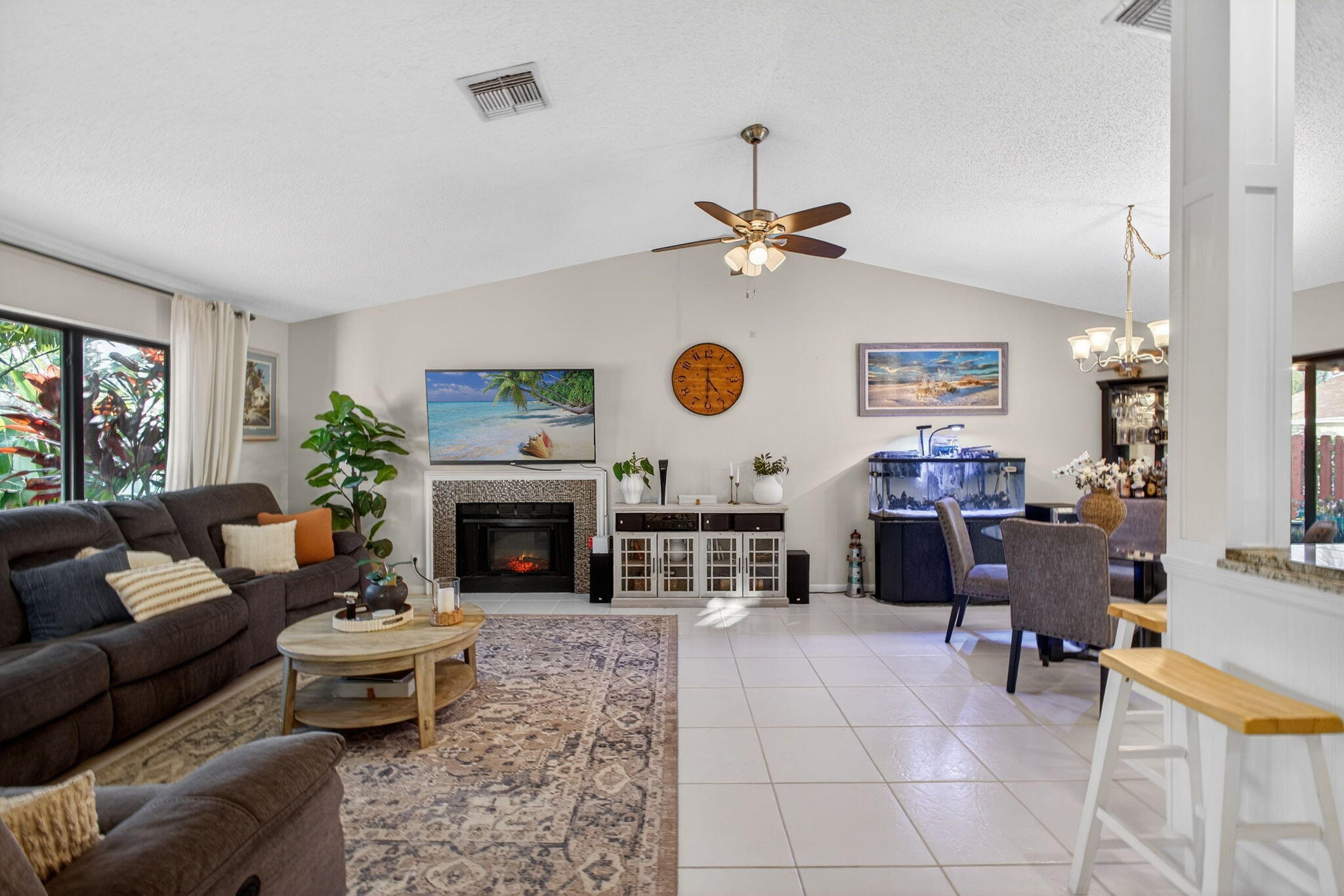 154 Rosewood Circle Jupiter, FL 33458 - Photo 7 of 43 a living room with furniture a fireplace and a flat screen tv