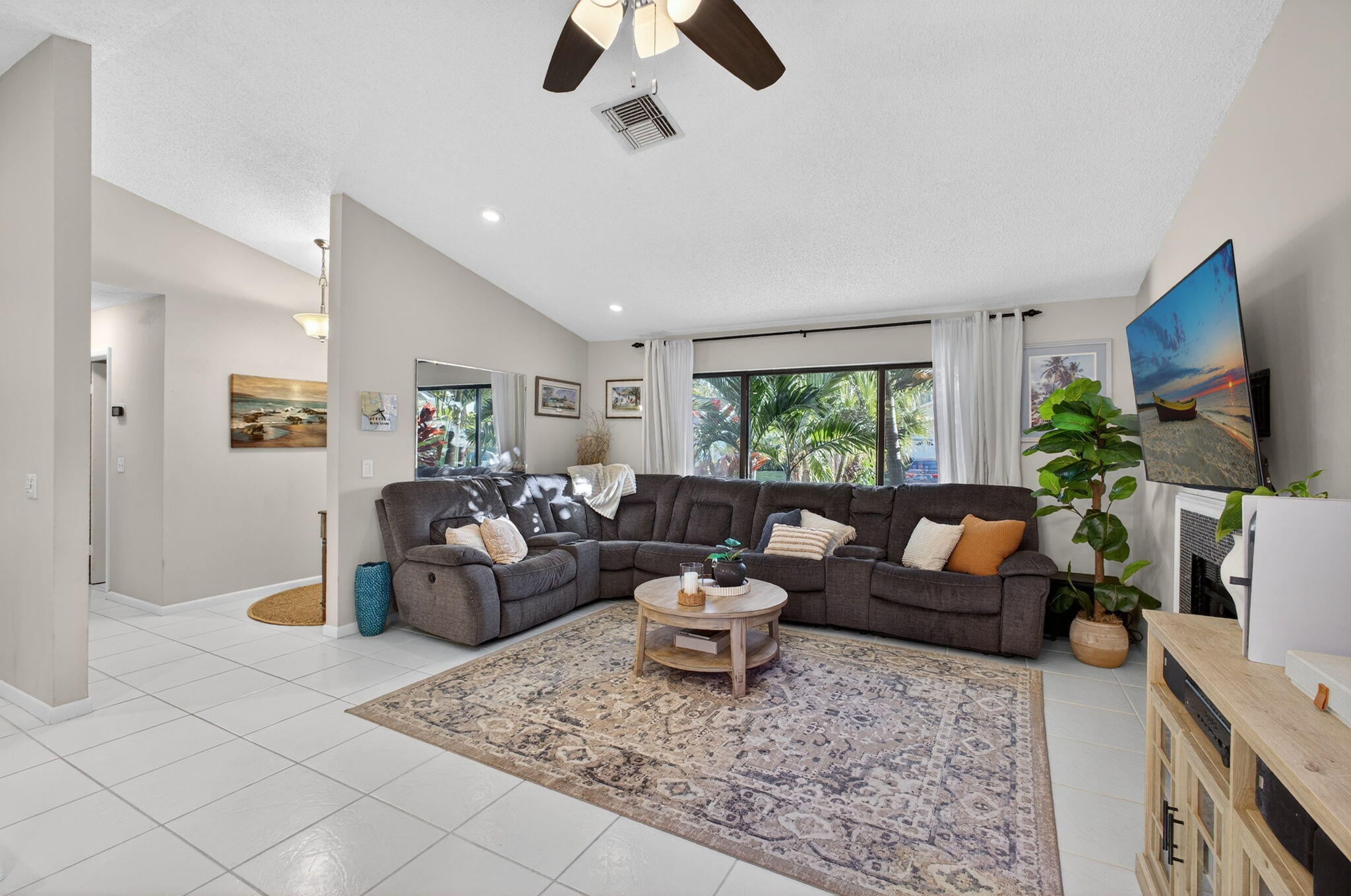 154 Rosewood Circle Jupiter, FL 33458 - Photo 9 of 43 a living room with furniture and a flat screen tv