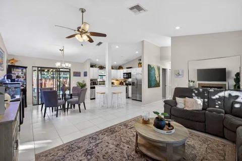 a living room with furniture a fireplace a rug and a window