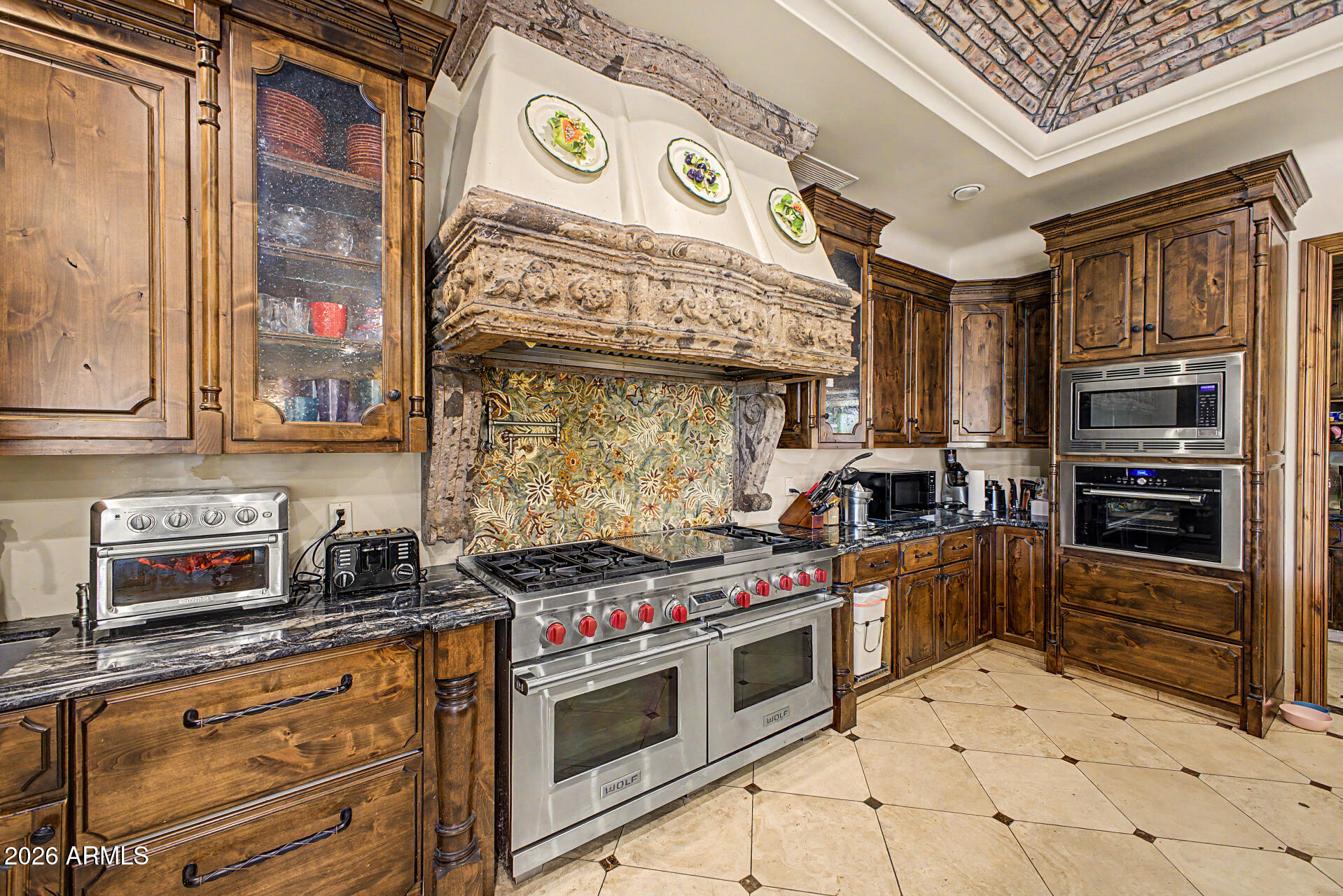 6525 North Lost Dutchman Road Paradise Valley, AZ 85253 - Photo 33 of 81 a kitchen with stainless steel appliances granite countertop a stove and a microwave