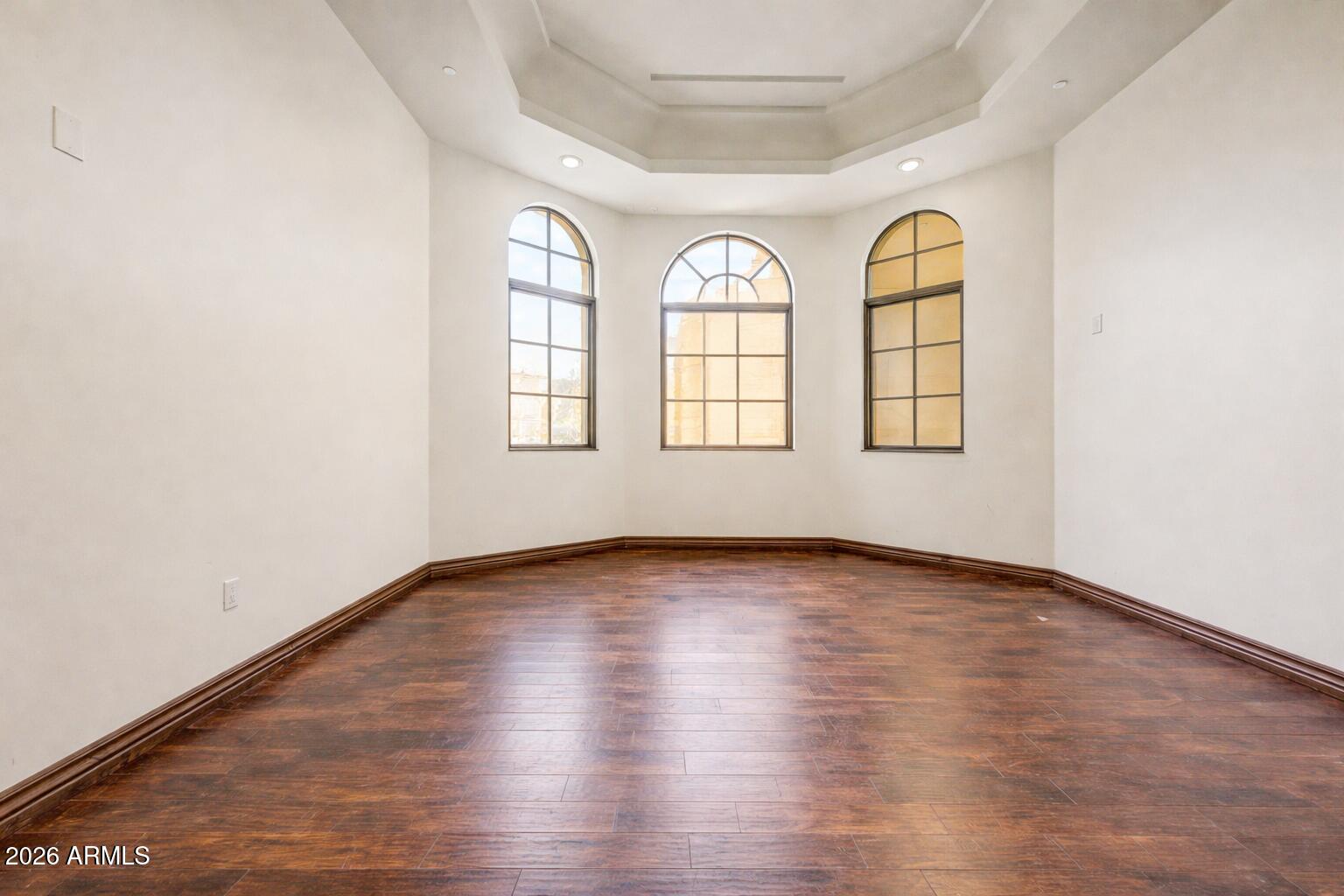 6525 North Lost Dutchman Road Paradise Valley, AZ 85253 - Photo 45 of 81 an empty room with wooden floor and window