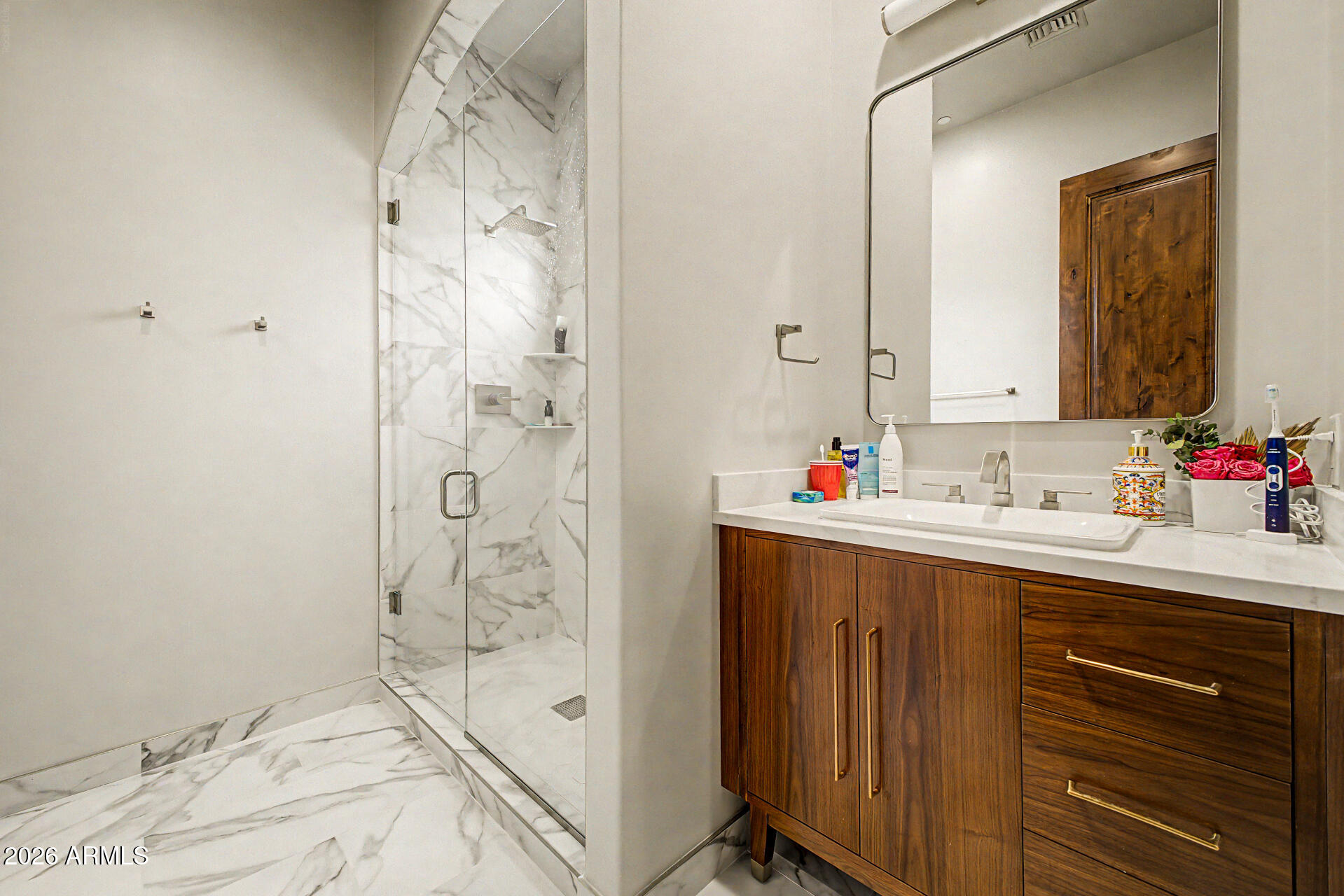 6525 North Lost Dutchman Road Paradise Valley, AZ 85253 - Photo 56 of 81 a bathroom with a shower sink and mirror