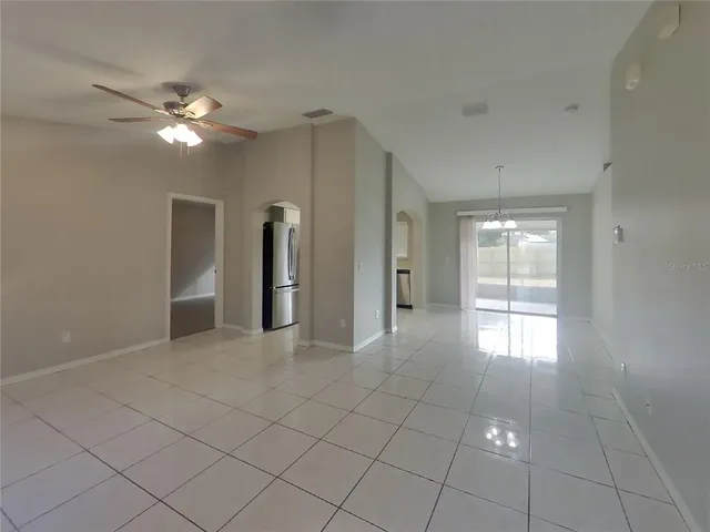 a view of a livingroom with a ceiling fan and window