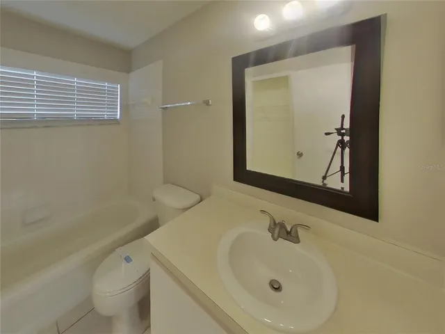 a bathroom with a sink a toilet and a bathtub