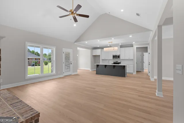 a view of kitchen and hall with wooden floor