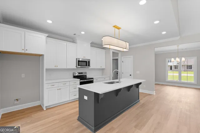 a kitchen with stainless steel appliances a sink stove and cabinets