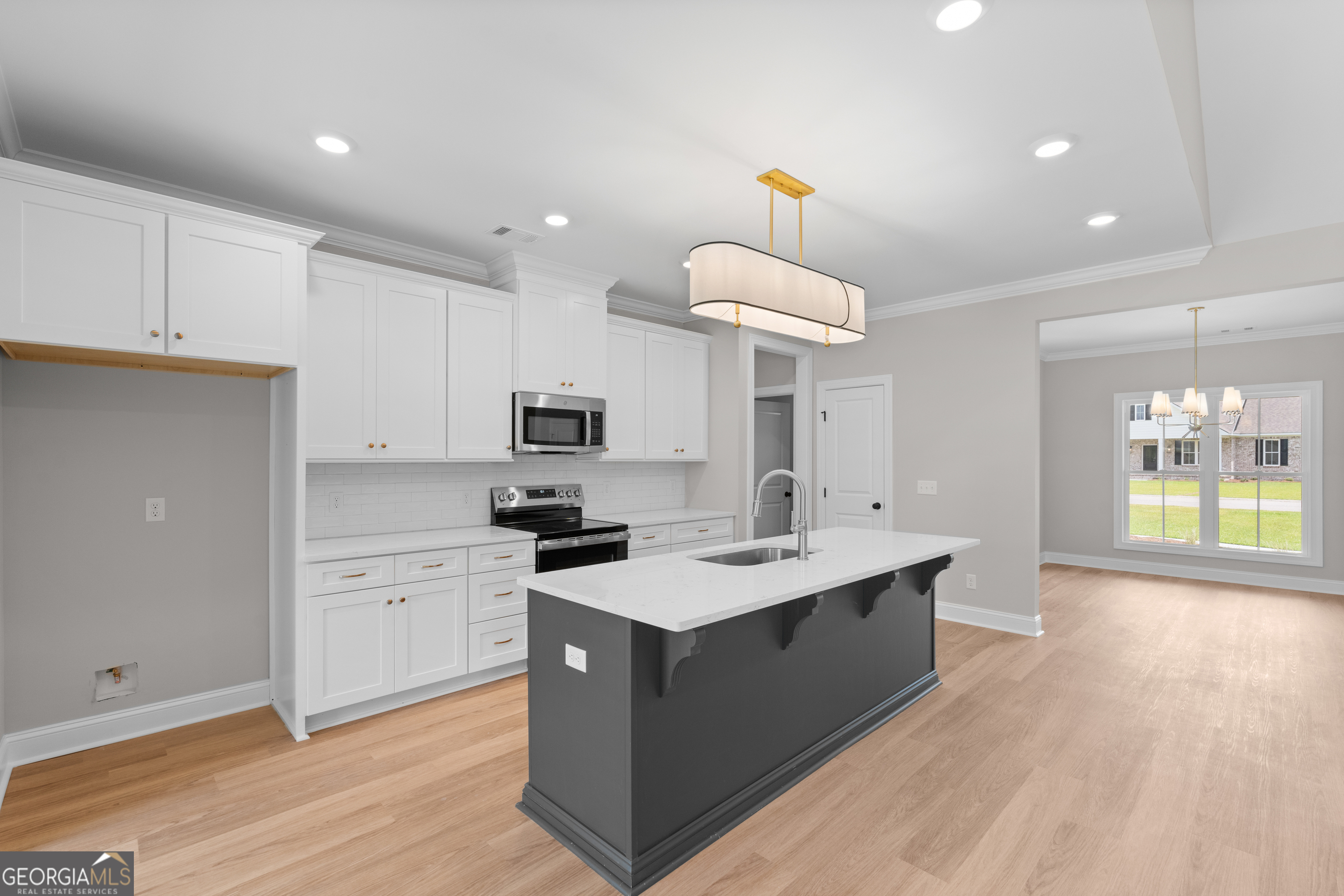 10 Honeysuckle Drive Claxton, GA 30417 - Photo 14 of 42 a kitchen with stainless steel appliances a sink stove and cabinets