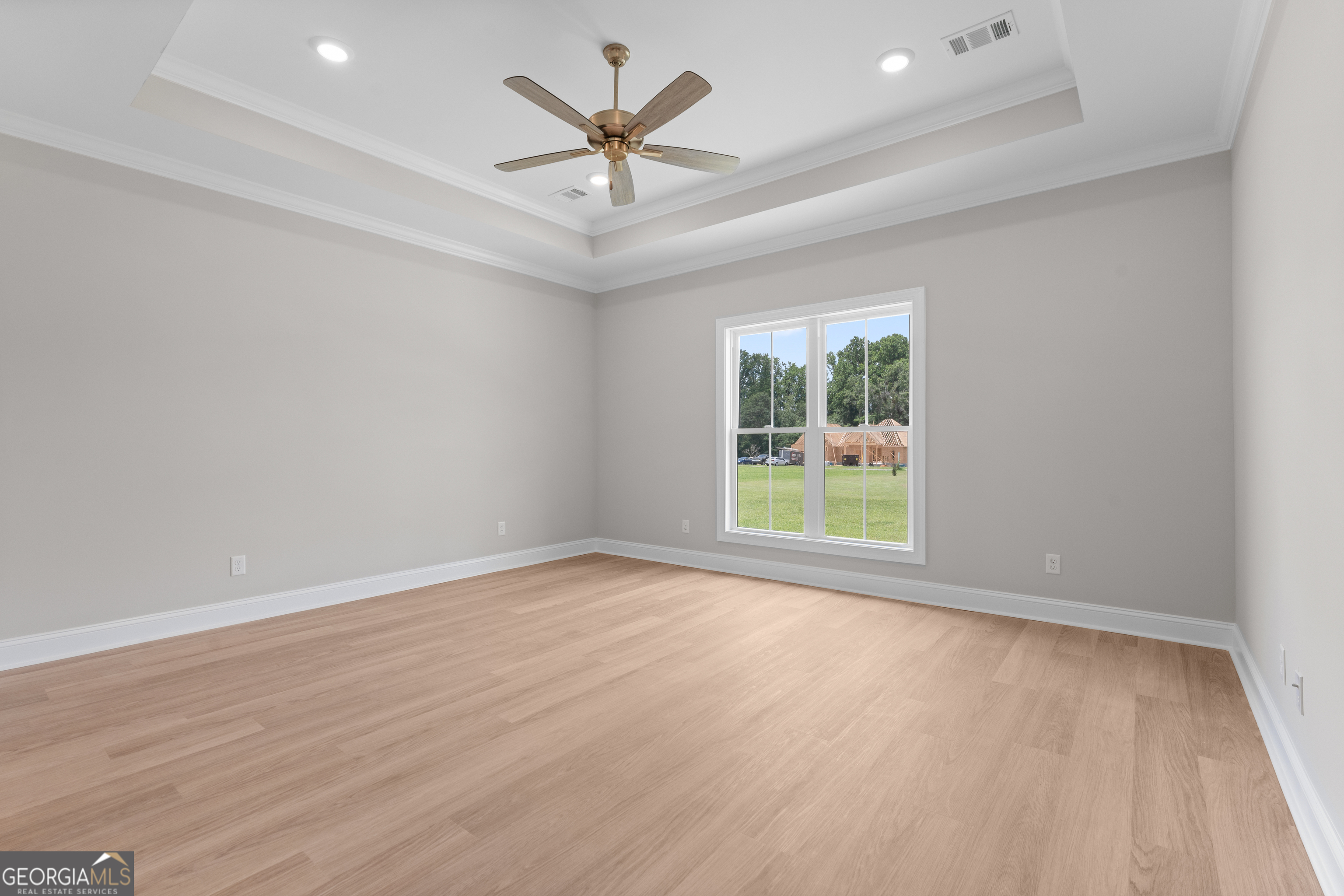 10 Honeysuckle Drive Claxton, GA 30417 - Photo 18 of 42 an empty room with wooden floor and windows