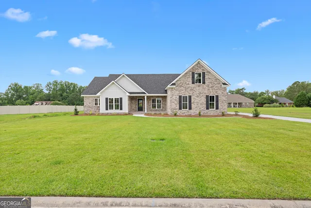 a view of house that has a big yard