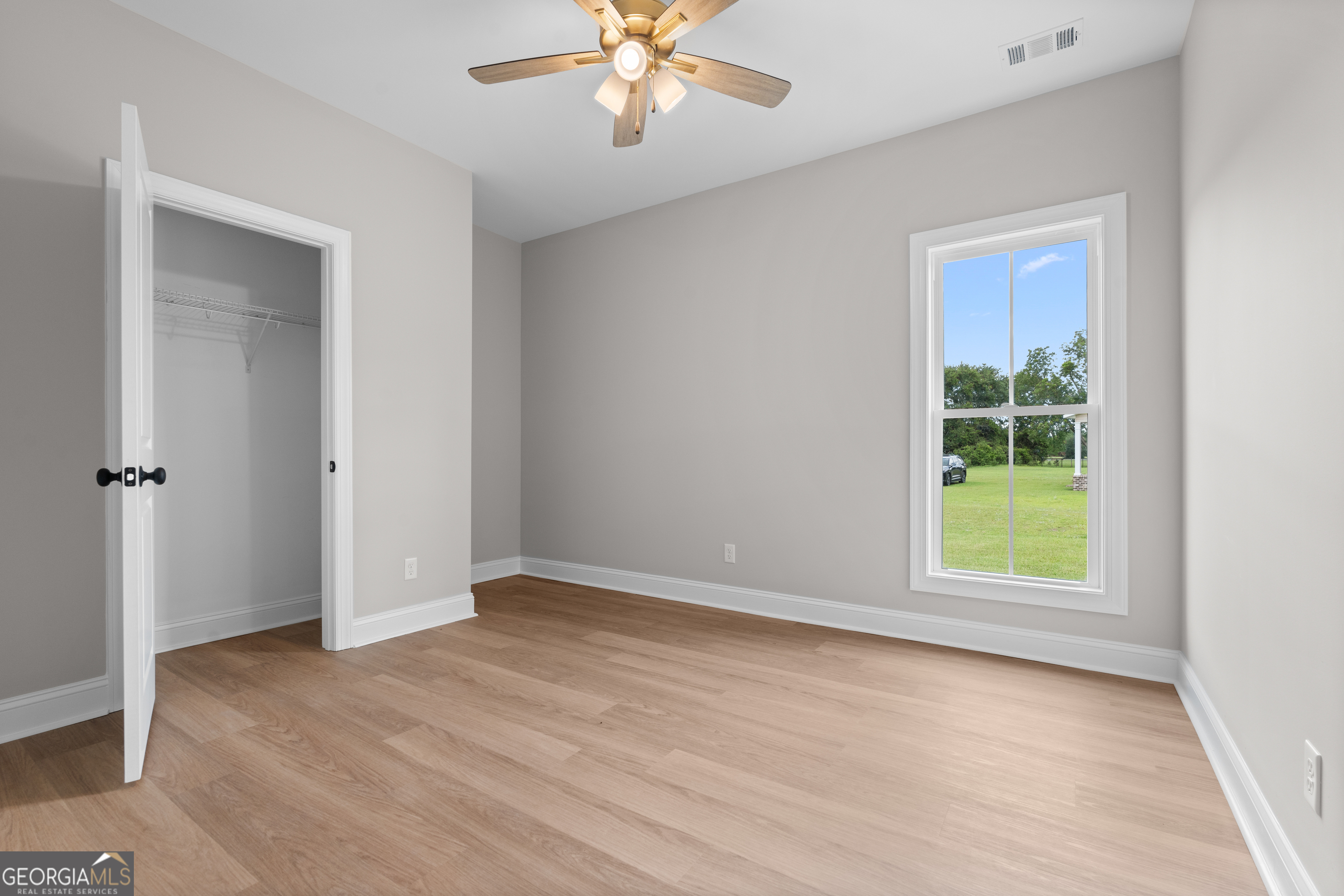 10 Honeysuckle Drive Claxton, GA 30417 - Photo 28 of 42 wooden floor in an empty room with a window