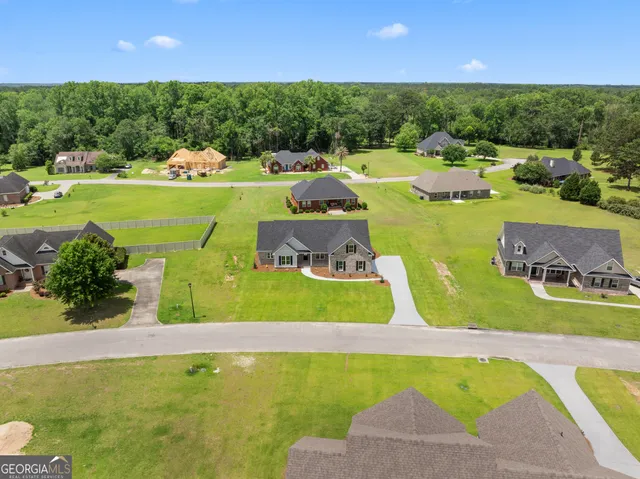 a view of a swimming pool and lounge chairs
