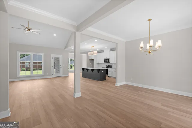 a view of a kitchen with a sink cabinet fire place and wooden floor