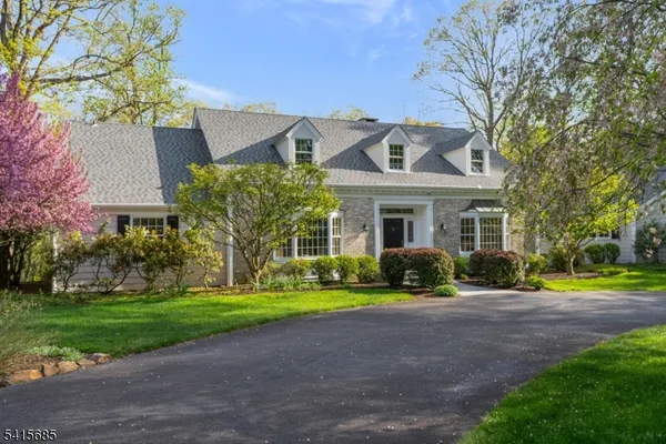 a front view of a house with garden and porch