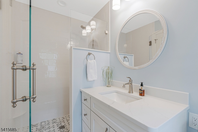 167 Ridge Road Watchung, NJ 07069 - Photo 25 of 50 a bathroom with a sink vanity and a mirror