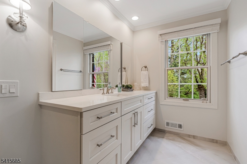 167 Ridge Road Watchung, NJ 07069 - Photo 27 of 50 a bathroom with a sink a mirror and a window
