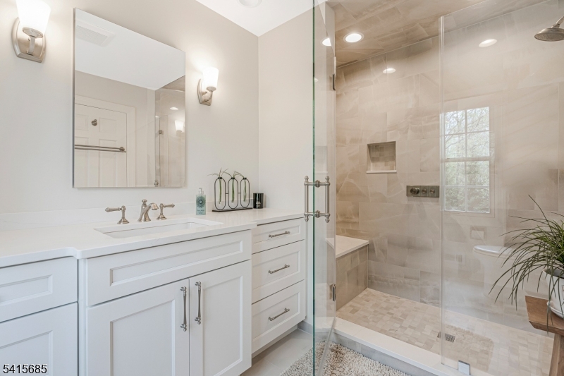 167 Ridge Road Watchung, NJ 07069 - Photo 28 of 50 a bathroom with a shower sink and mirror
