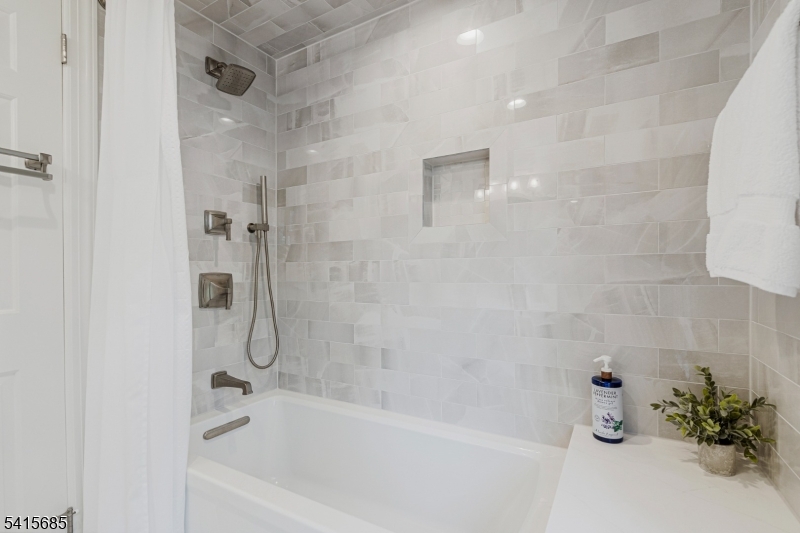 167 Ridge Road Watchung, NJ 07069 - Photo 32 of 50 a bathroom with a shower and a bathtub
