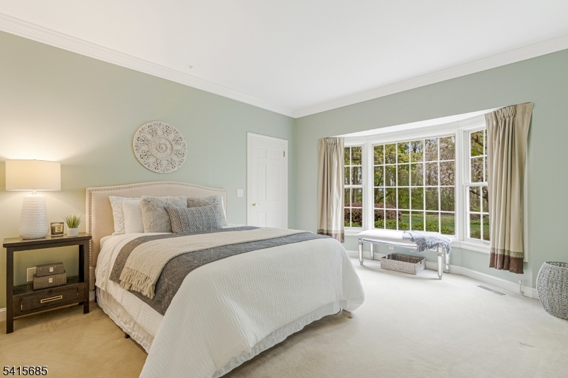 167 Ridge Road Watchung, NJ 07069 - Photo 33 of 50 a spacious bedroom with a bed and a large window