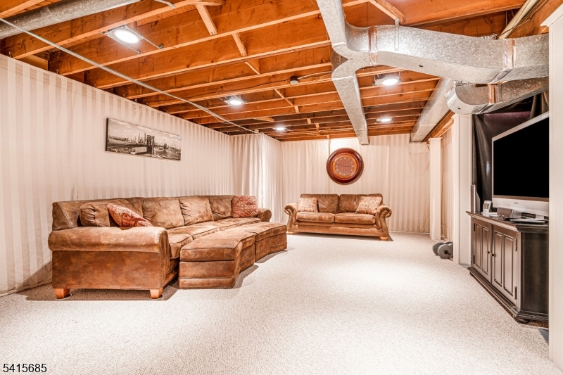 167 Ridge Road Watchung, NJ 07069 - Photo 36 of 50 a living room with furniture and a flat screen tv