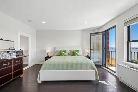 a bedroom with a large bed and a dresser