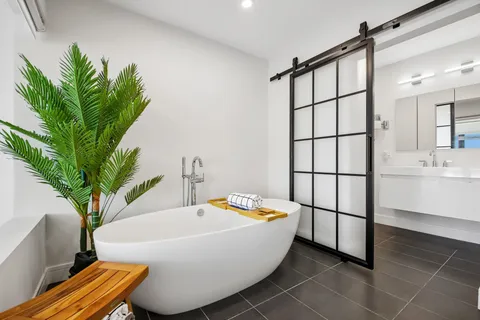 a white bath tub sitting in a bathroom next to a sink