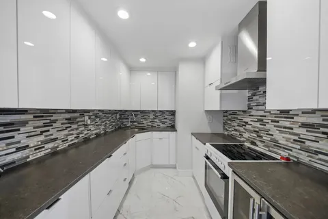 a kitchen with granite countertop a stove and a sink
