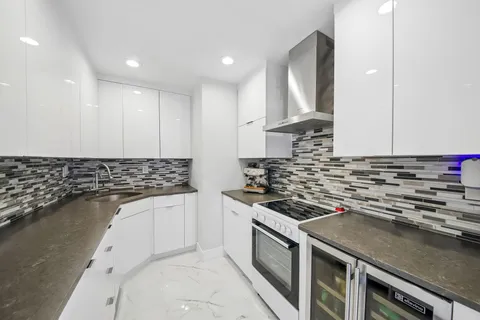 a kitchen with granite countertop a stove and a sink