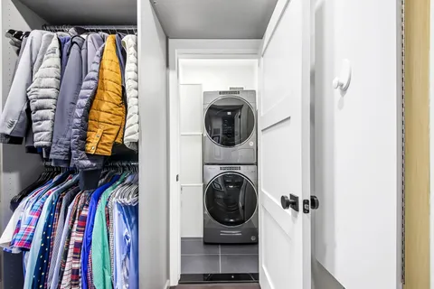a view of walk in closet with clothes and shoes
