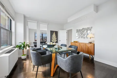 a dining room with furniture and wooden floor
