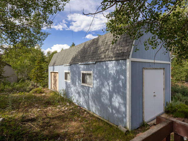4770 Pine Crest Road Evanston, UT 82930 - Photo 17 of 24 Barn-style auxiliary building featuring a gambrel roof and light blue exterior siding