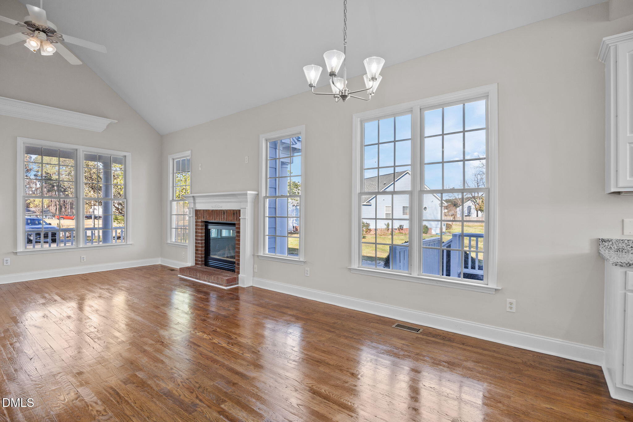 118 Kayleigh Court Willow Spring, NC 27592 - Photo 13 of 37 a view of an empty room with wooden floor and a window