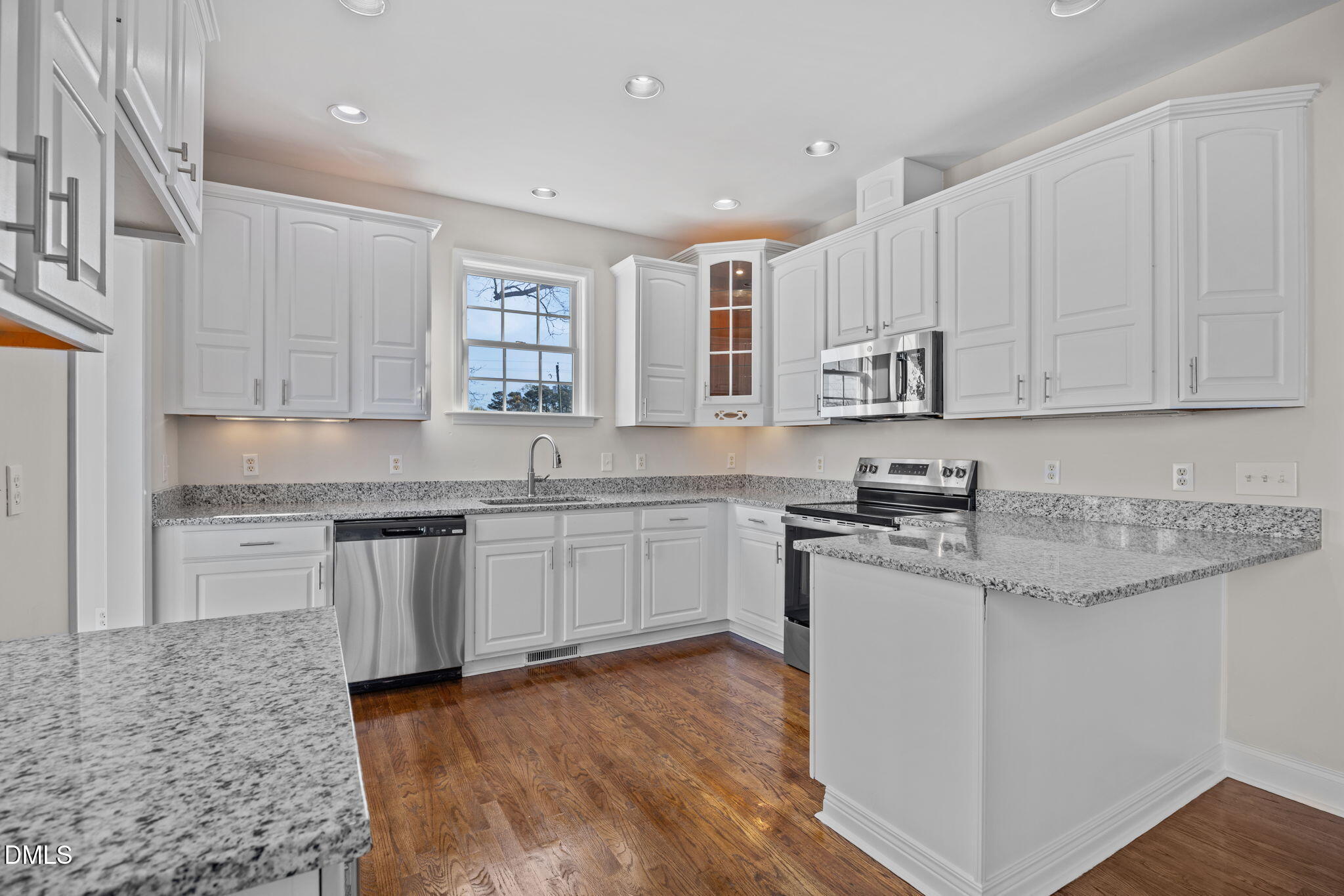 118 Kayleigh Court Willow Spring, NC 27592 - Photo 14 of 37 a kitchen with stainless steel appliances granite countertop a stove a sink and a microwave
