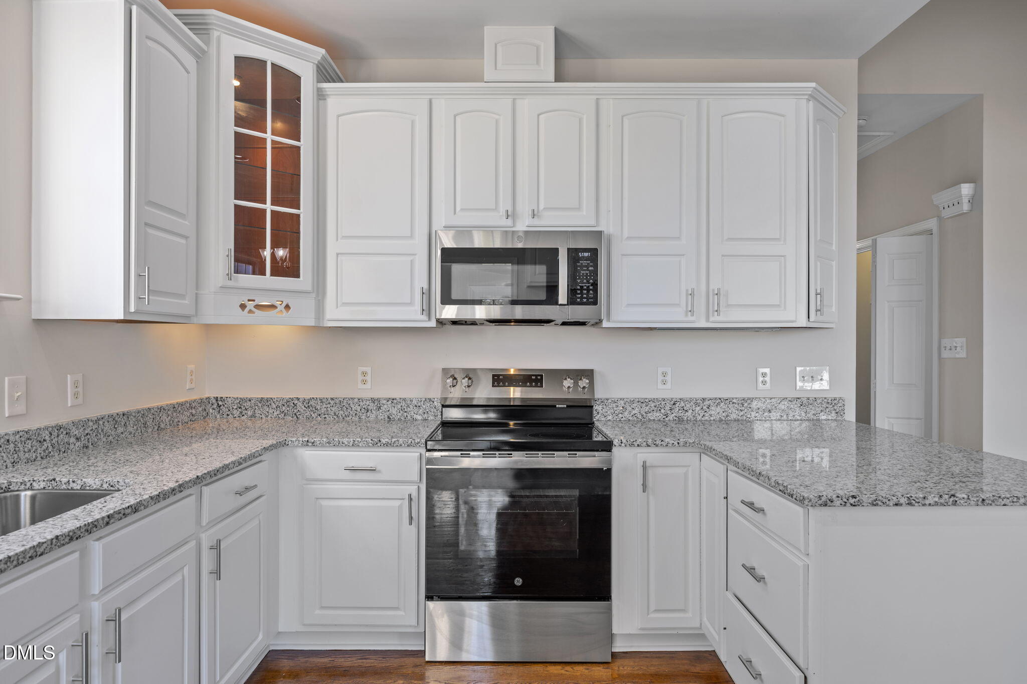 118 Kayleigh Court Willow Spring, NC 27592 - Photo 17 of 37 a kitchen with stainless steel appliances granite countertop a stove a microwave and a white cabinets
