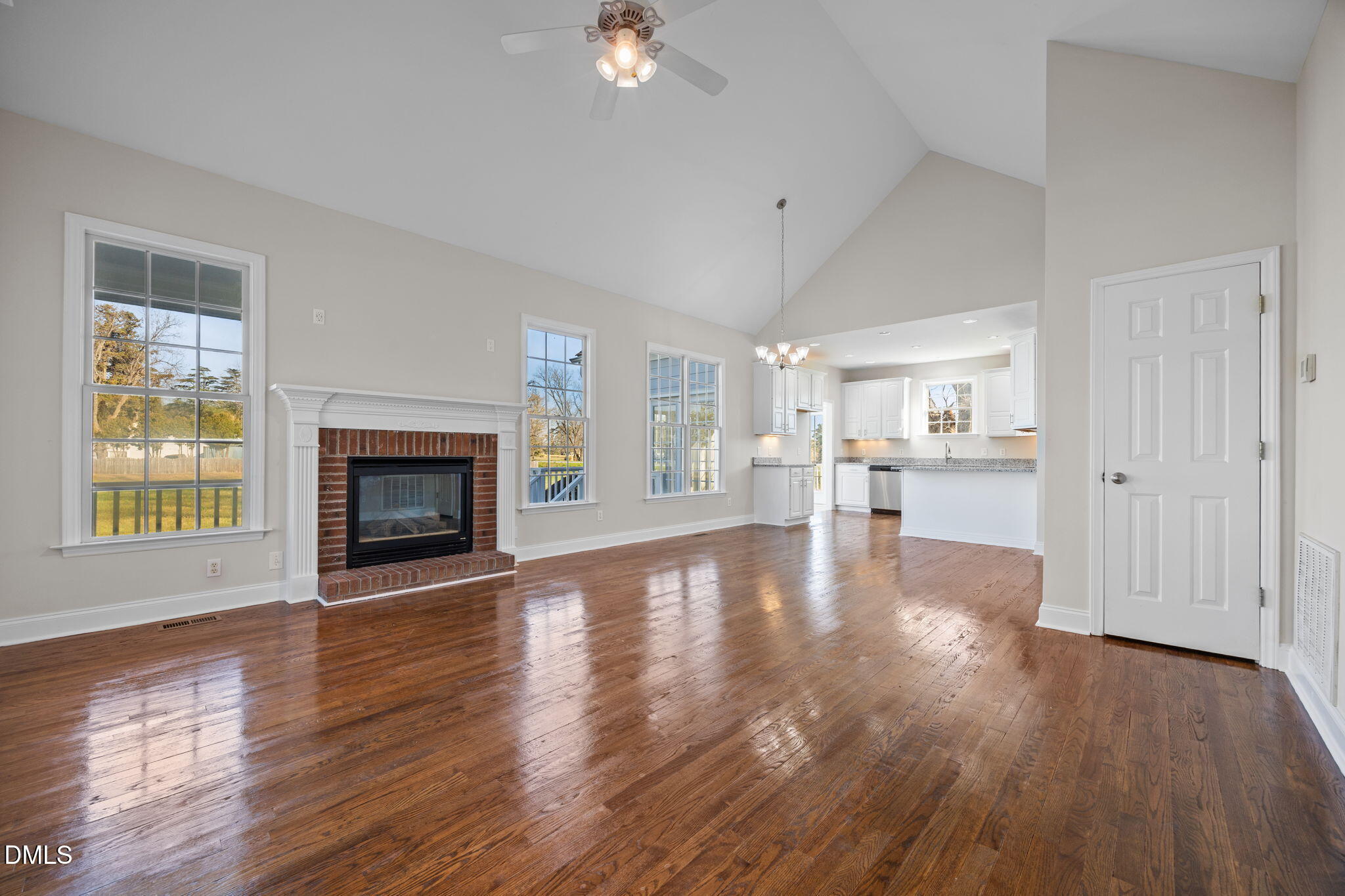118 Kayleigh Court Willow Spring, NC 27592 - Photo 2 of 37 a view of empty room with wooden floor and fireplace