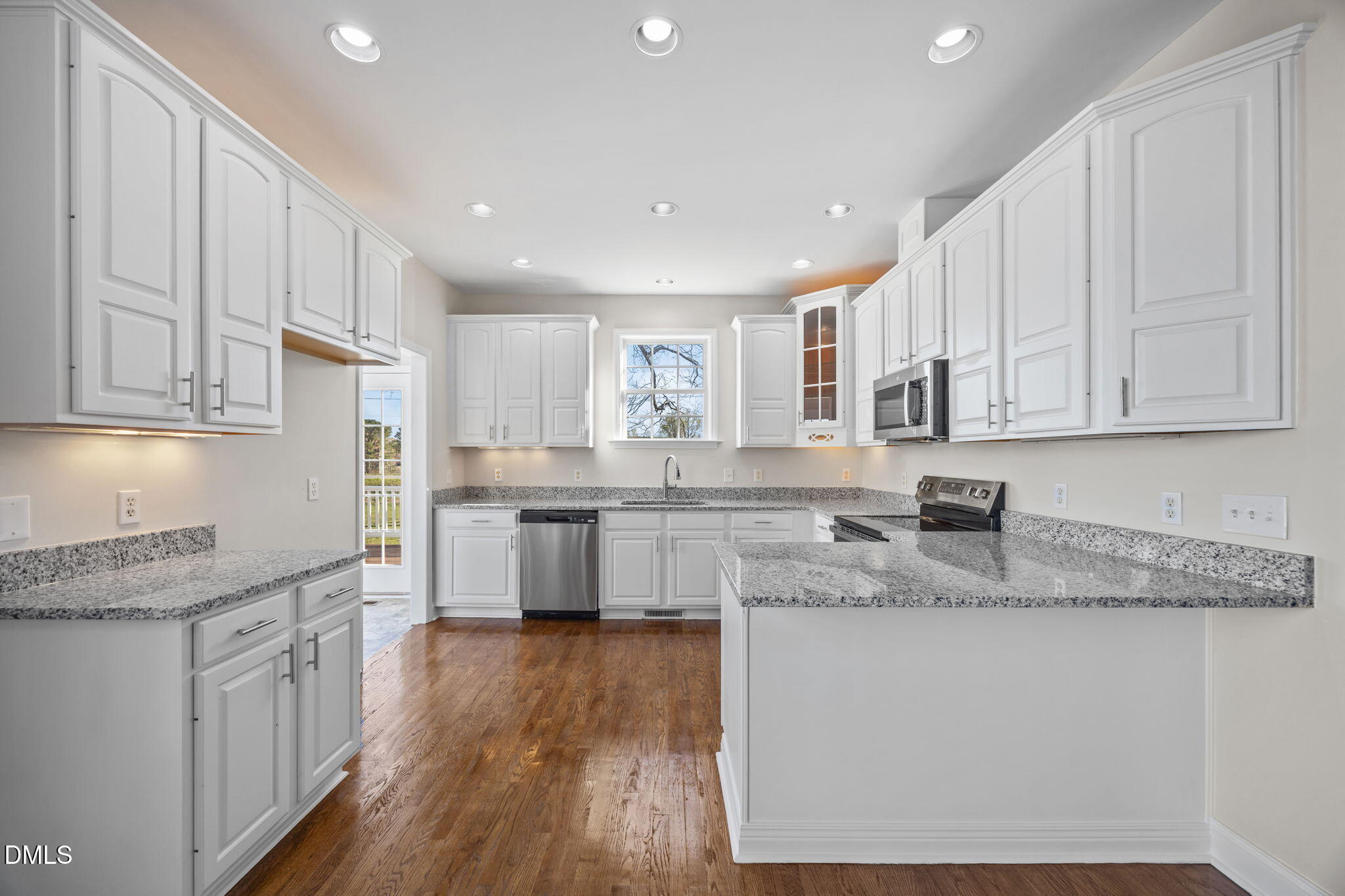 118 Kayleigh Court Willow Spring, NC 27592 - Photo 3 of 37 a kitchen with granite countertop white cabinets and white stainless steel appliances