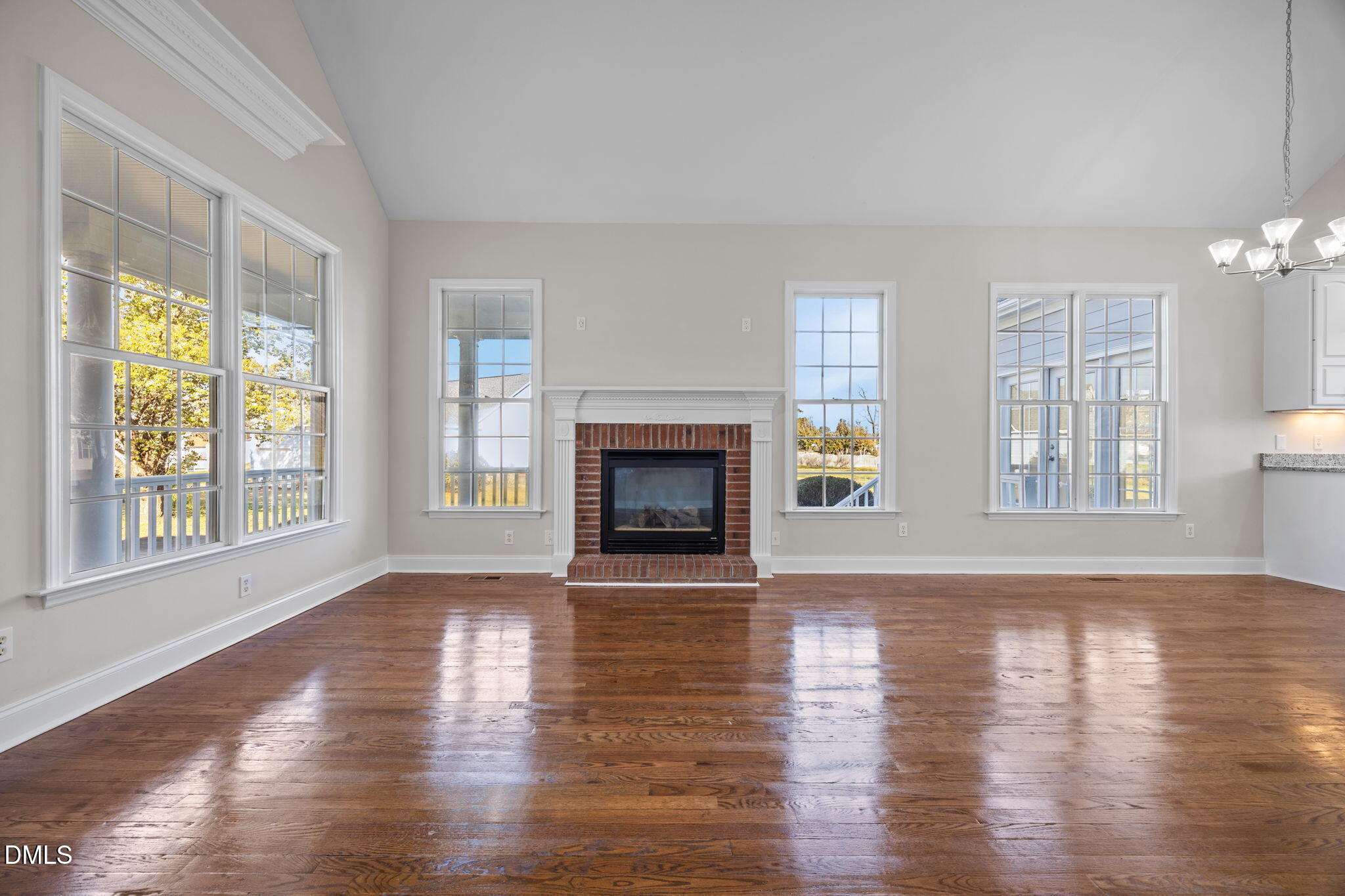 118 Kayleigh Court Willow Spring, NC 27592 - Photo 9 of 37 a view of an empty room with wooden floor and a window
