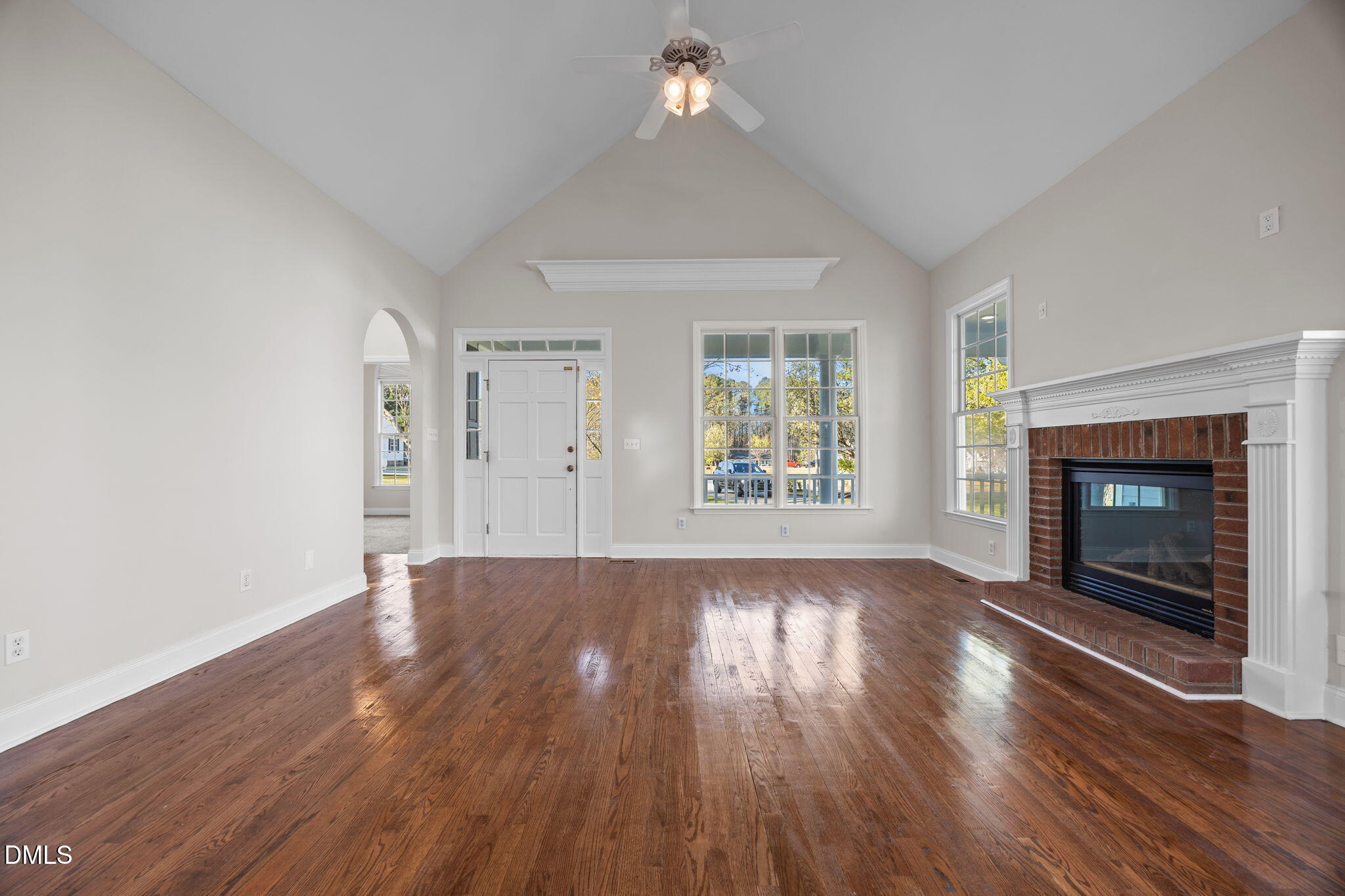 118 Kayleigh Court Willow Spring, NC 27592 - Photo 10 of 37 an empty room with wooden floor fireplace and windows