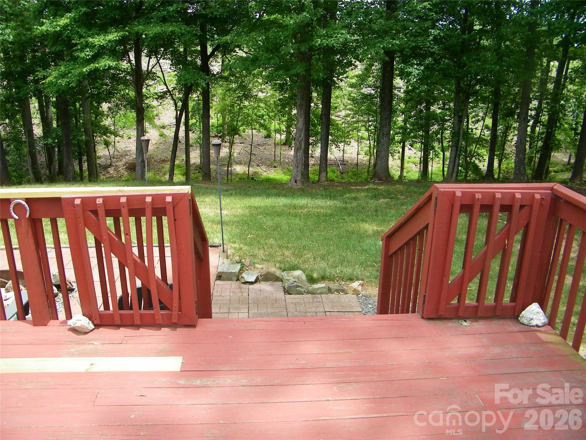 609 Redah Avenue Locust, NC 28097 - Photo 33 of 37 a view of a backyard with large trees and wooden fence