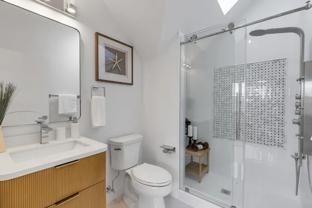 a bathroom with a sink toilet and shower