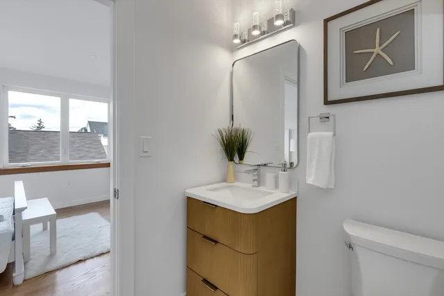 a bathroom with a sink vanity and mirror