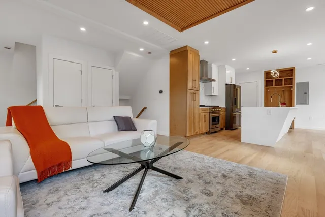a living room with furniture and kitchen view