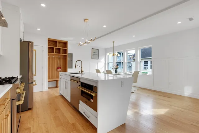 a kitchen with stainless steel appliances granite countertop a stove and a refrigerator