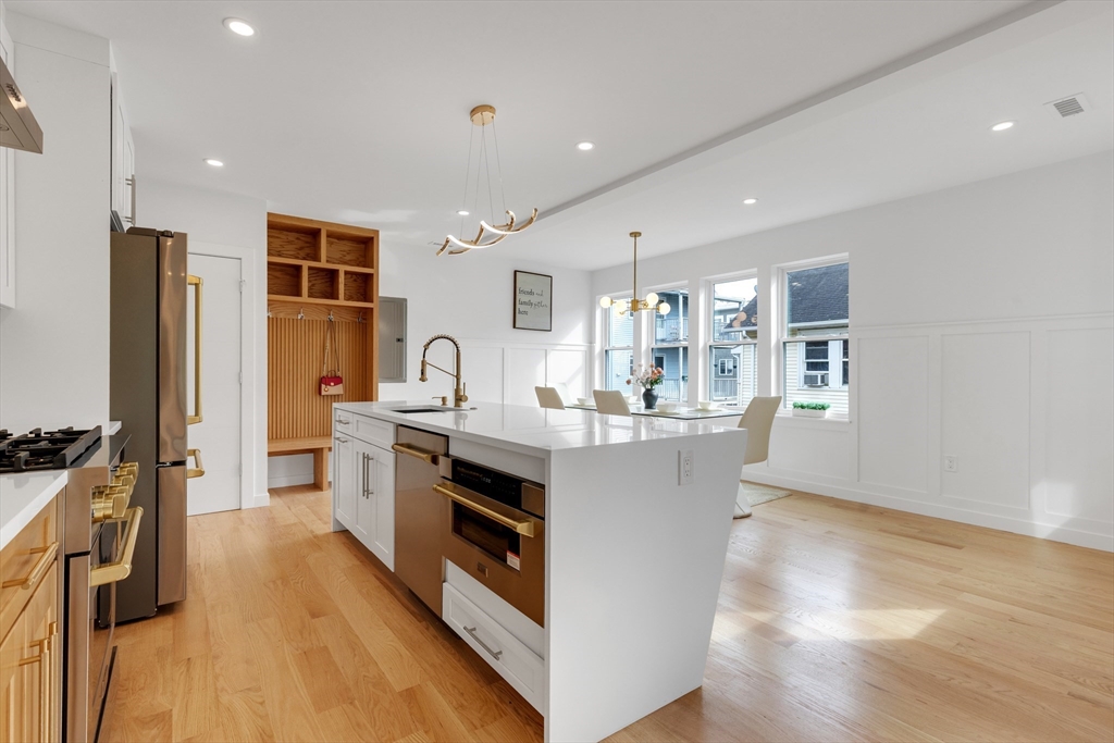 69 Boston Avenue, Unit 69 Somerville, MA 02144 - Photo 5 of 26 a kitchen with stainless steel appliances granite countertop a stove and a refrigerator