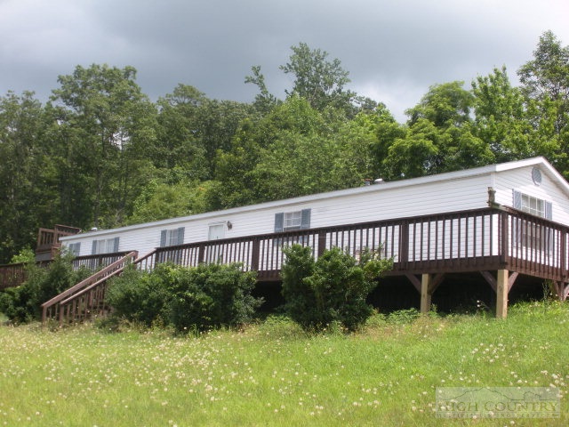 73 Smith Acres Road Ennice, NC 28623 - Photo 1 of 22 a view of a yard with a chair