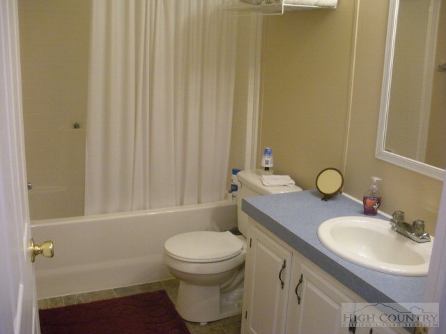 73 Smith Acres Road Ennice, NC 28623 - Photo 11 of 22 a bathroom with a sink a toilet and shower
